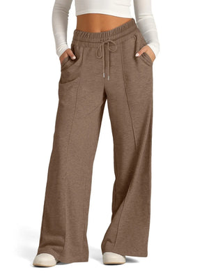 Brown wide-leg pants worn by a person on a white background