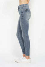 Light blue jeans worn by a person on a white background