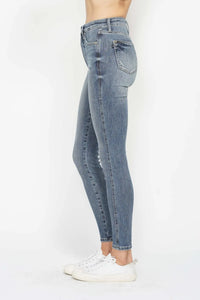 Light blue jeans worn by a person on a white background