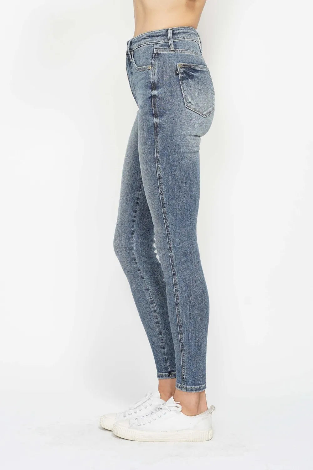 Light blue jeans worn by a person on a white background