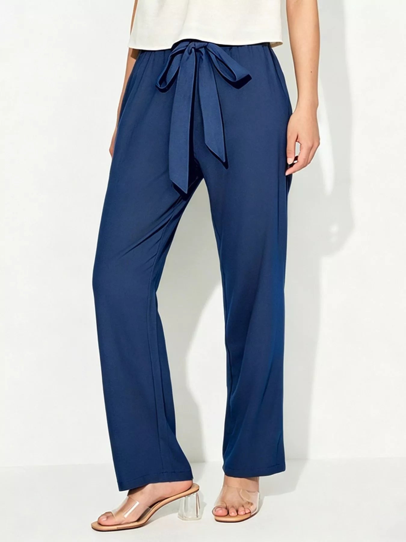 Blue wide-leg pants with a tie waist on a white background