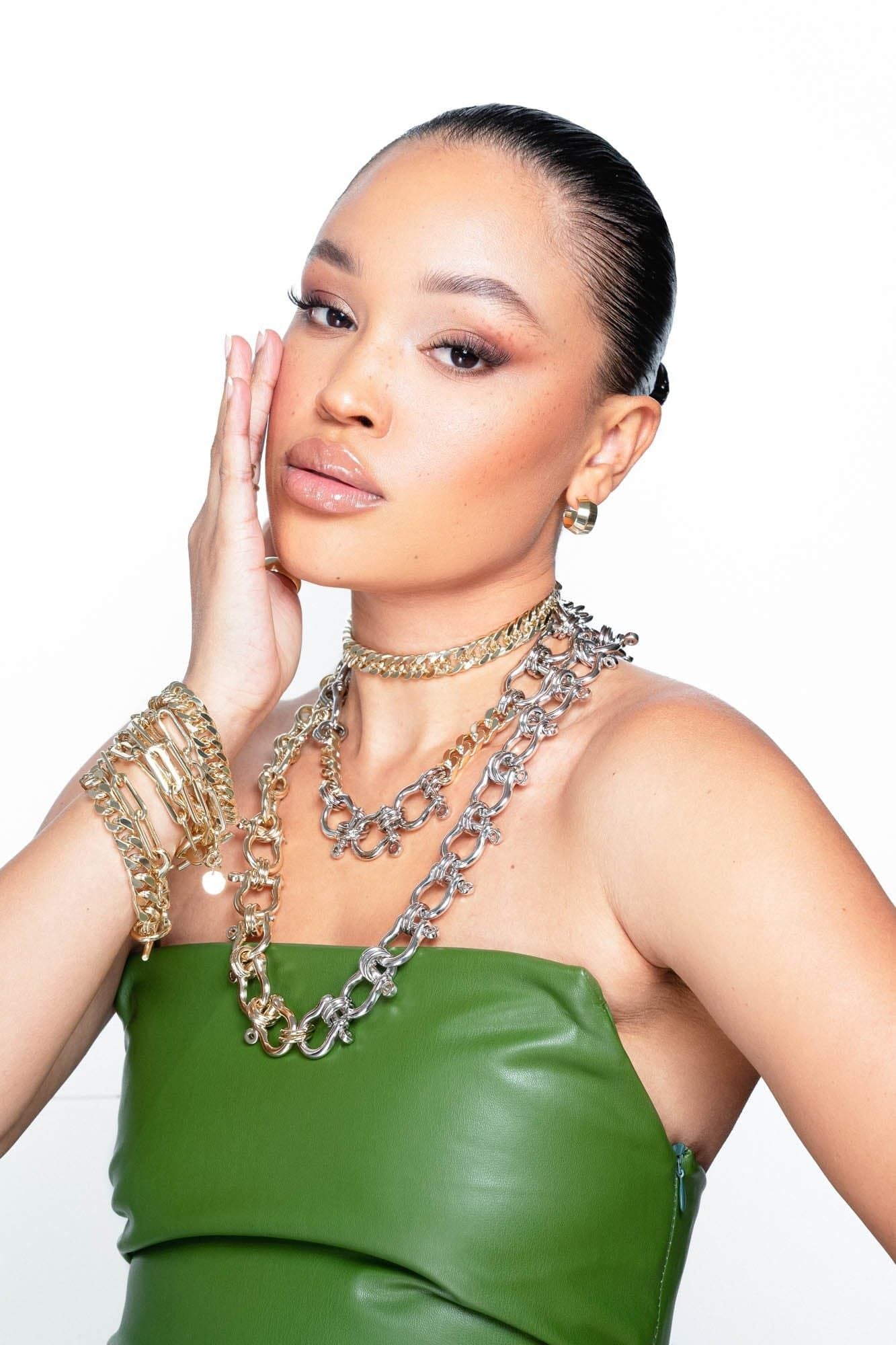 Model wearing a green leather dress and Arya Necklace around her neck