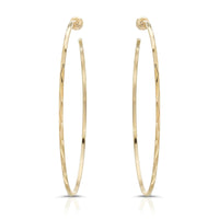 A pair of gold-colored hoop earrings with a textured surface, showing a front and back view.