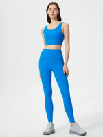 Woman wearing a blue athletic outfit on a white background
