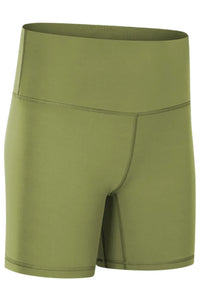 Green athletic shorts on a white background