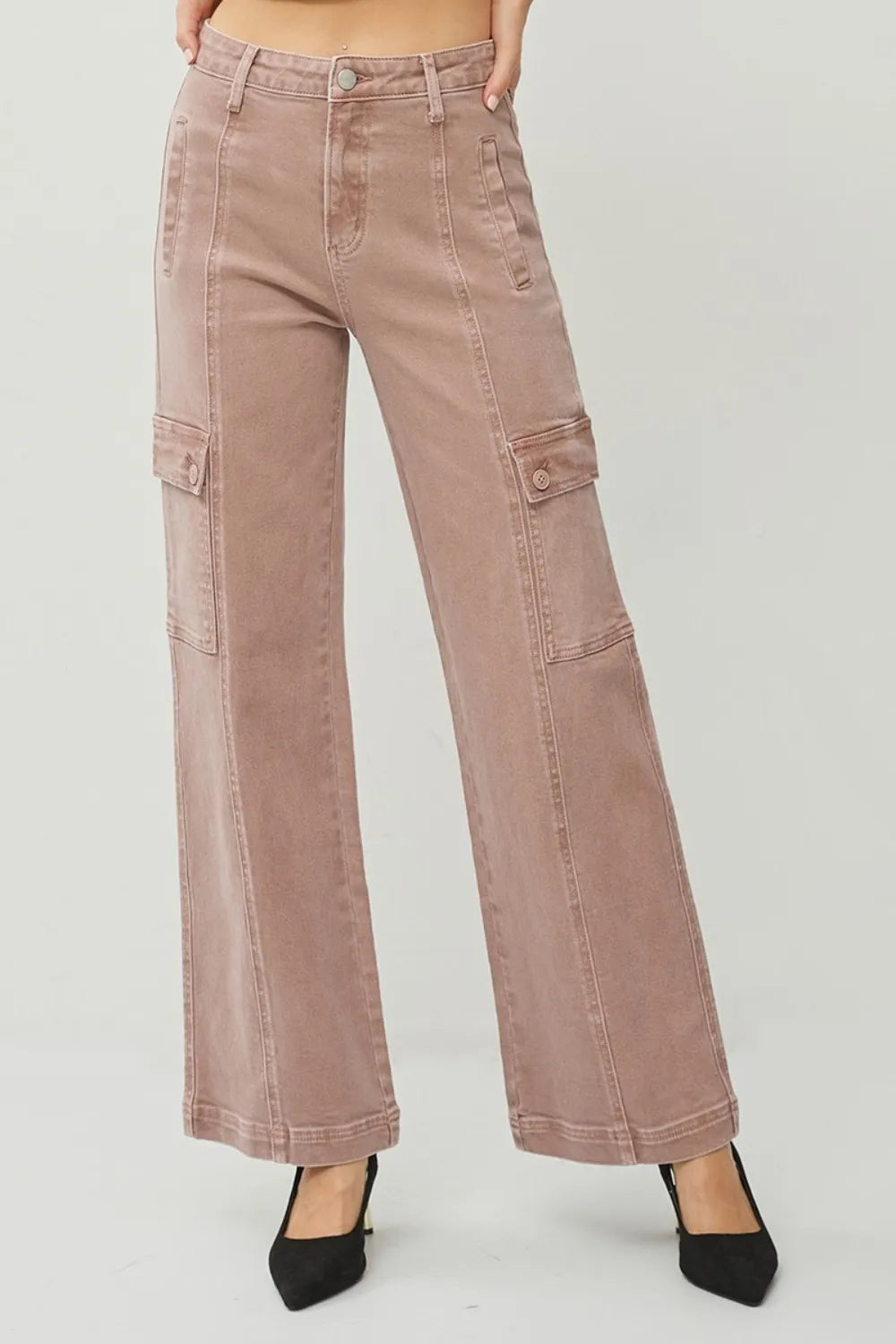 Pink cargo pants on a plain background