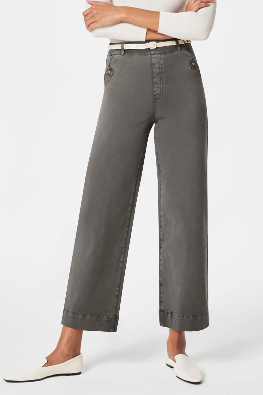 Person wearing gray wide-leg pants on a white background