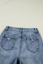Blue denim jeans with a plain background