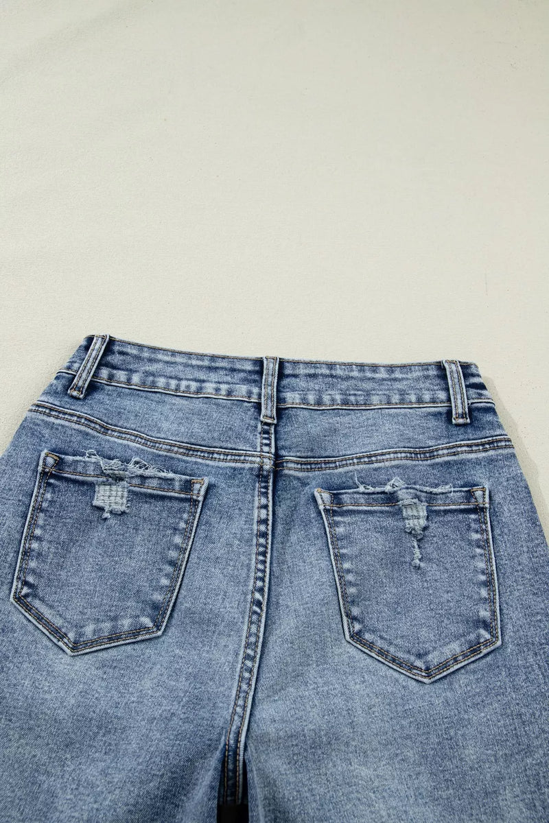 Blue denim jeans with a plain background