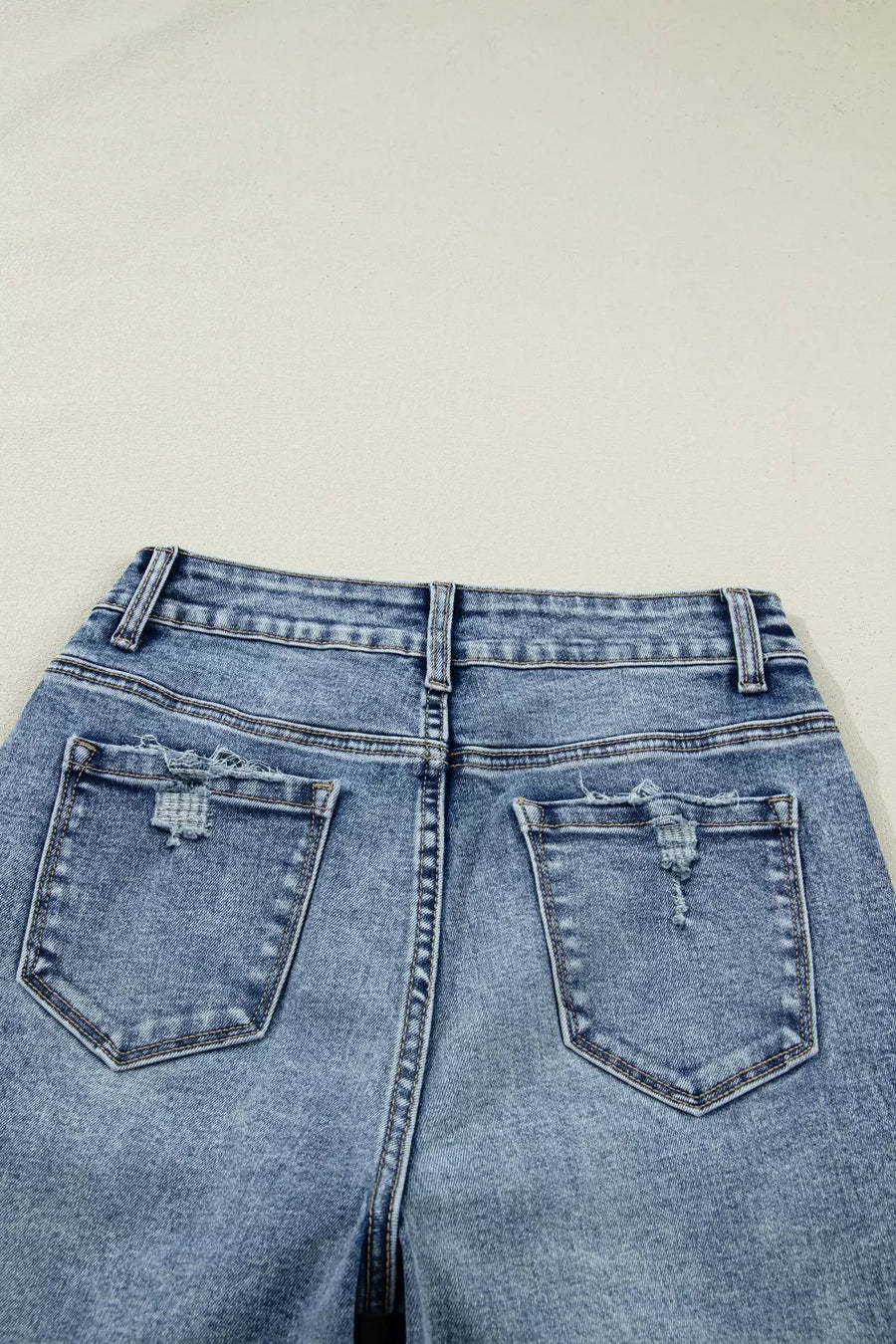 Blue denim jeans with a plain background