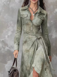 Woman wearing a green tie-dye dress against a textured gray background