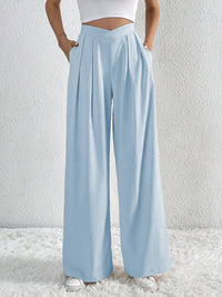Light blue wide-leg pants worn by a person on a white background