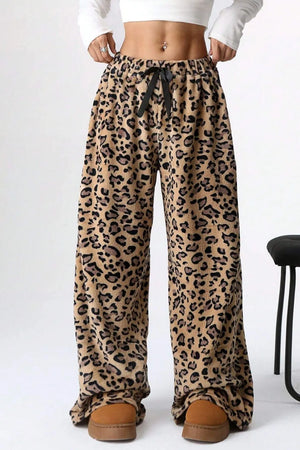 Leopard print pants worn by a person on a white background