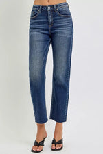 Blue jeans worn by a person on a white background