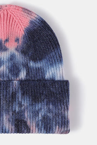 Tie-dye beanie with pink and blue patterns on a white background