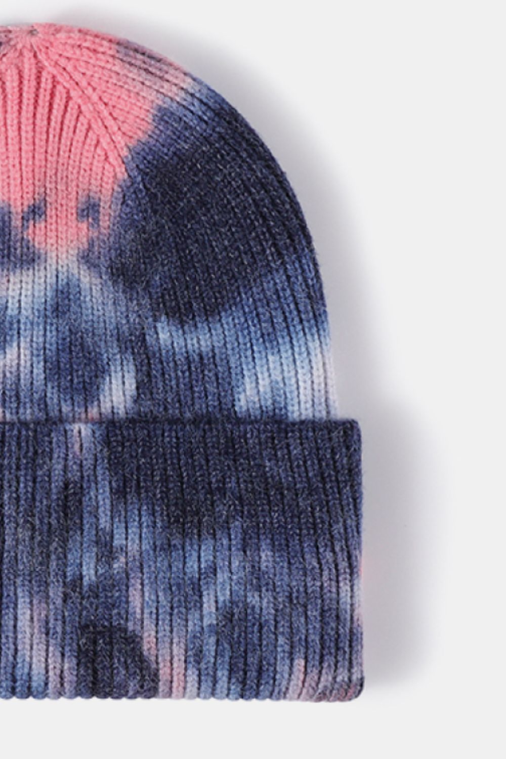 Tie-dye beanie with pink and blue patterns on a white background