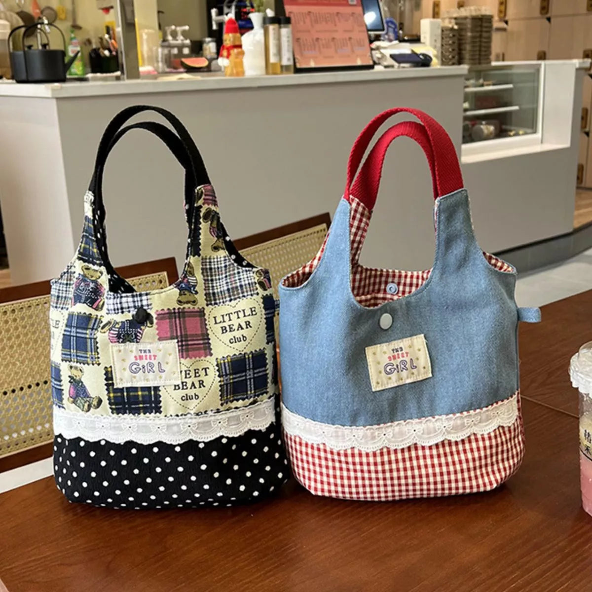 Two fabric bags, one plaid and polka dot, the other denim with red checkered accents, on a wooden surface.