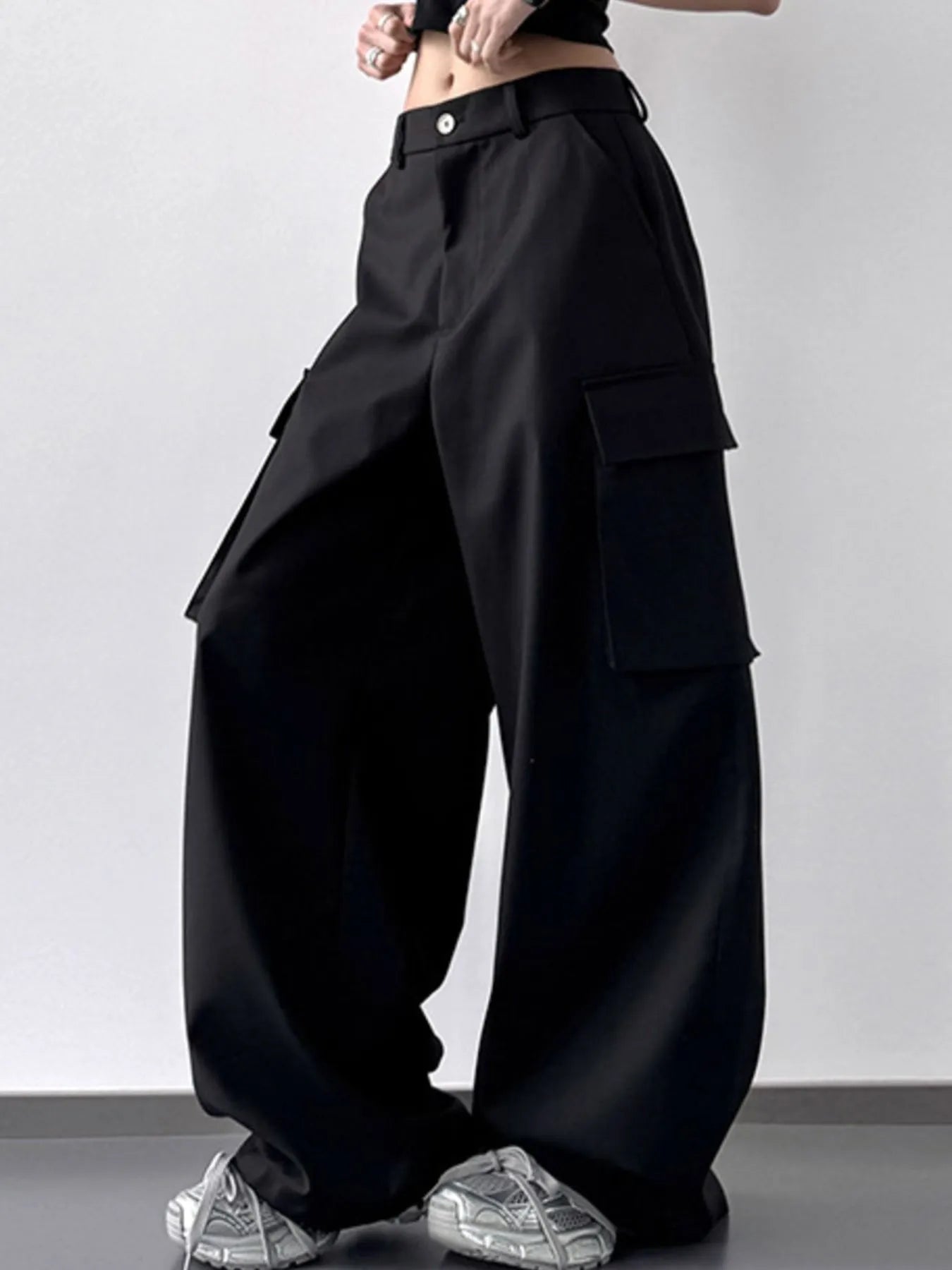 Black wide-leg pants worn by a person on a plain background
