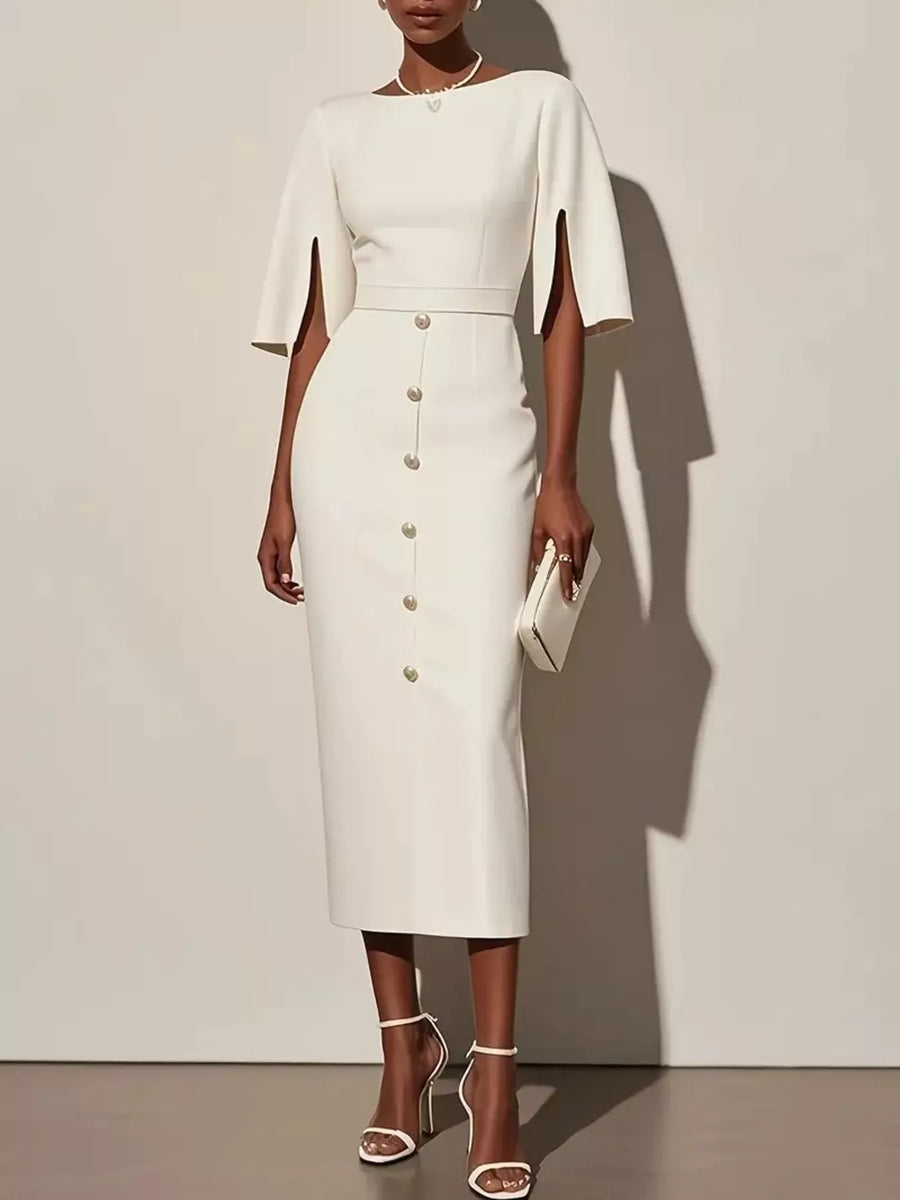 Woman wearing a white dress with cape sleeves against a plain background