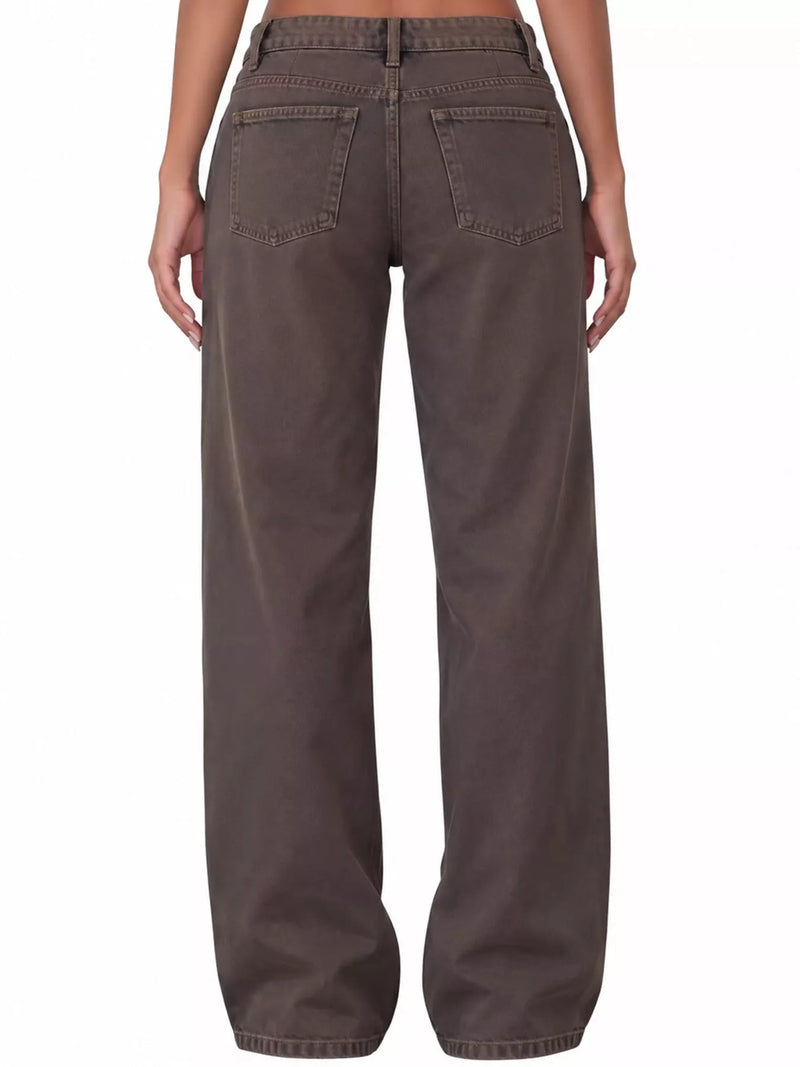 Rear view of a person wearing wide-leg brown pants against a plain white background.