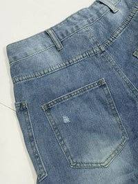 Close-up of blue denim jeans with a pocket on a white background