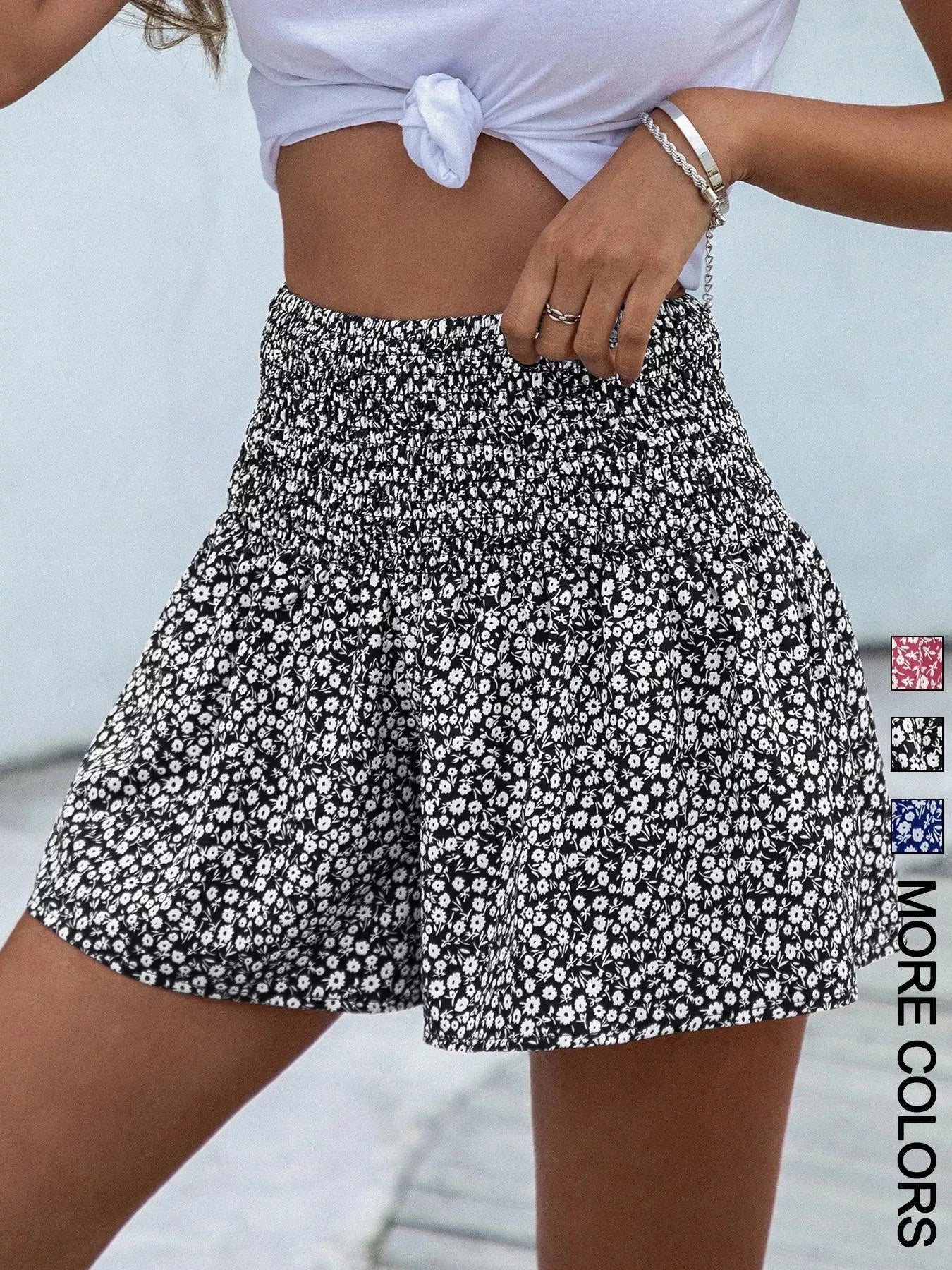 Person wearing a black and white floral skirt with a blurred background
