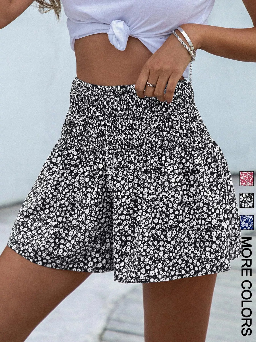 Person wearing a black and white floral skirt with a blurred background
