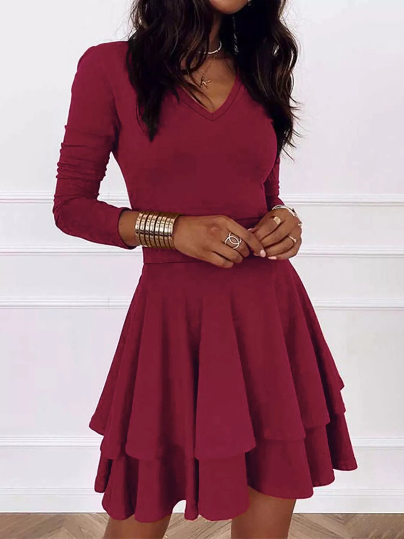 Maroon dress worn by a person against a white background
