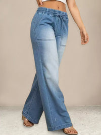 Light blue jeans worn by a person on a neutral background