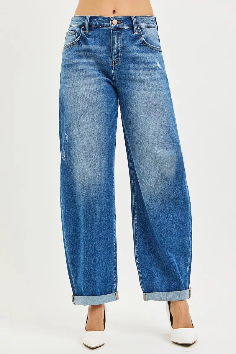 Blue jeans worn by a person on a white background