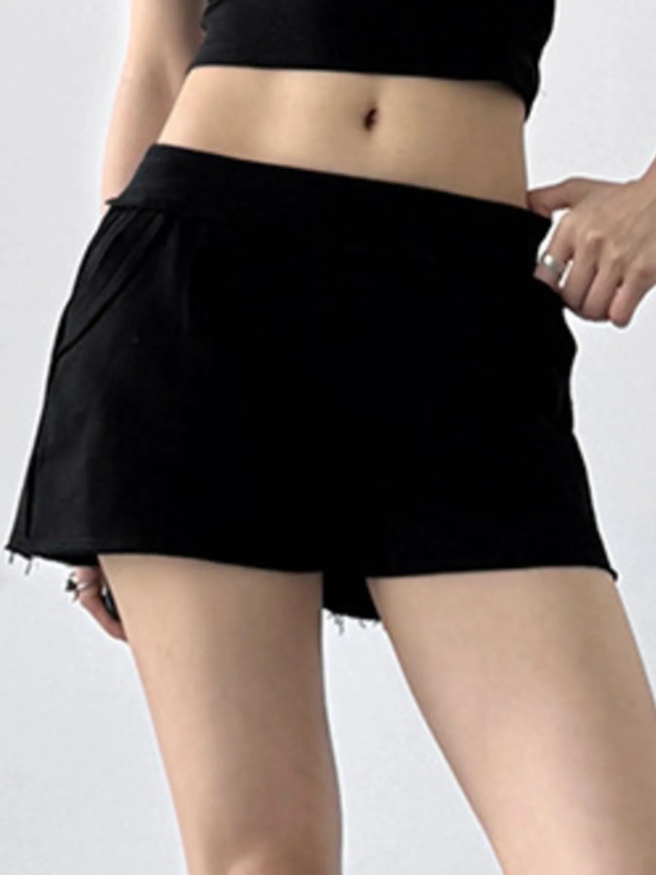 Black skirt worn by a person on a plain background