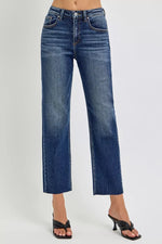 Blue jeans worn by a person on a gray background
