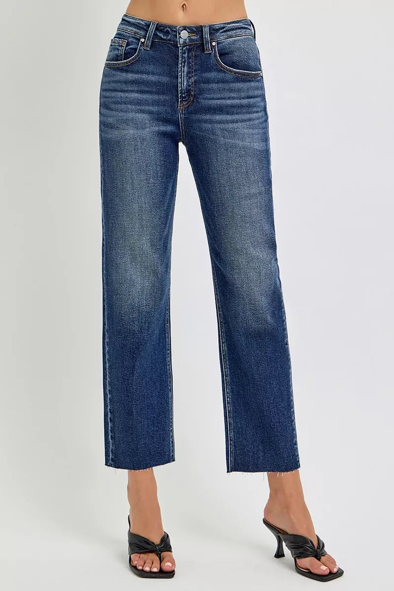 Blue jeans worn by a person on a gray background