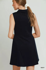 Woman wearing a black dress with a white background