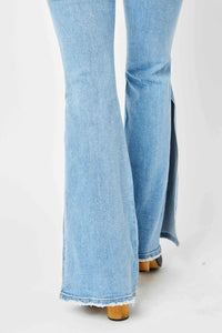 Light blue flared jeans on a white background