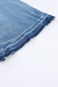 Close-up of a blue denim fabric edge on a white background