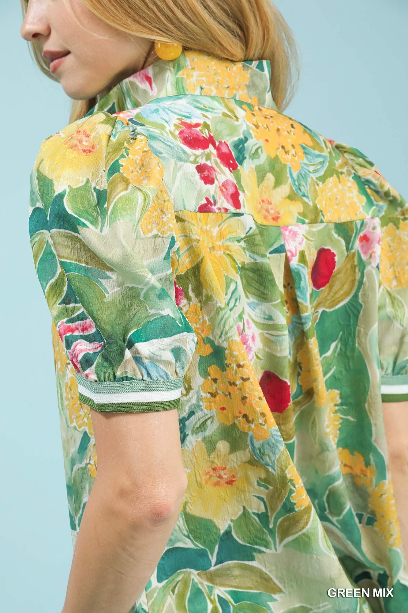 Woman wearing a floral dress with a green background