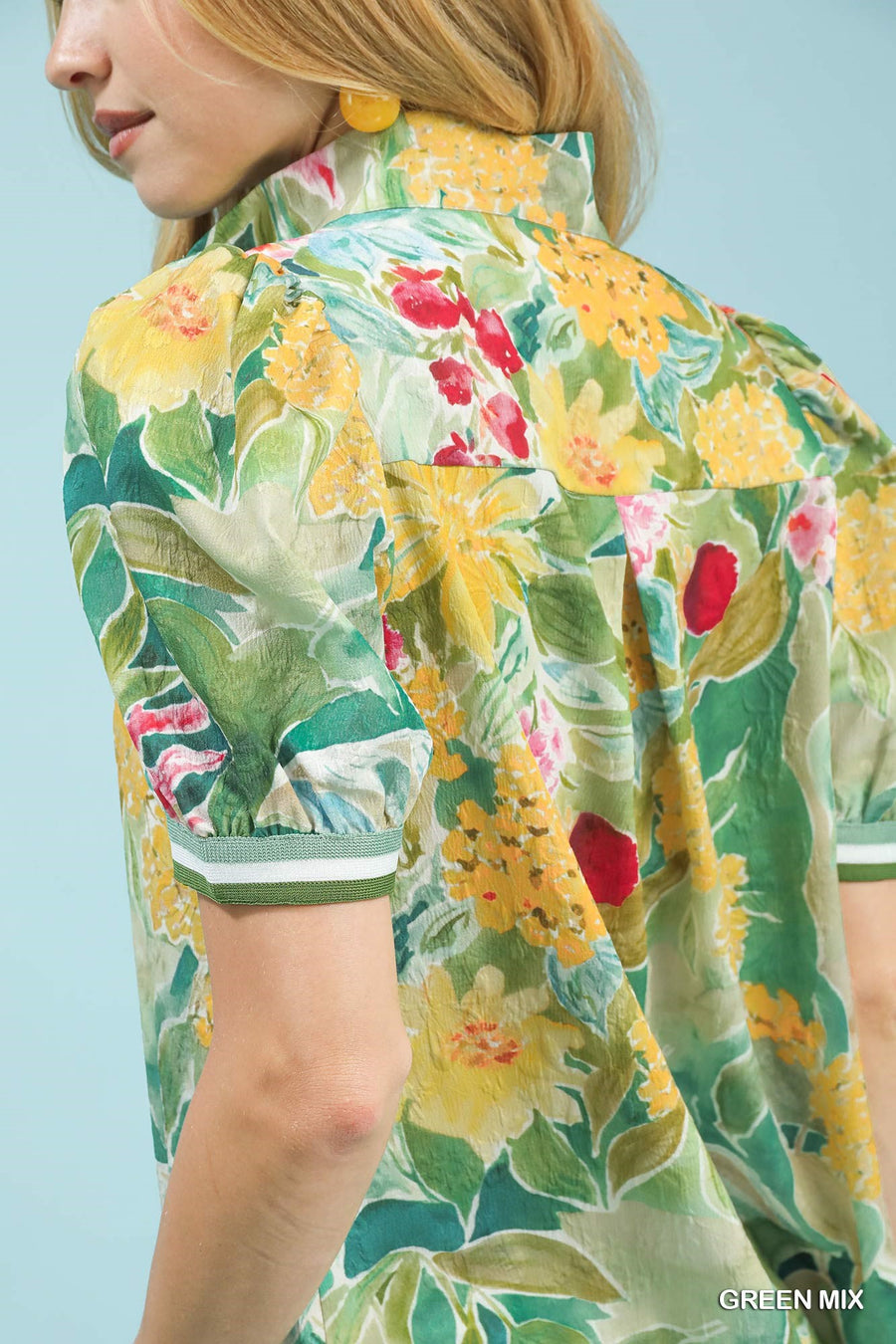 Woman wearing a floral dress with a green background