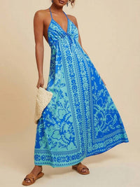 Woman wearing a blue patterned dress on a beige background