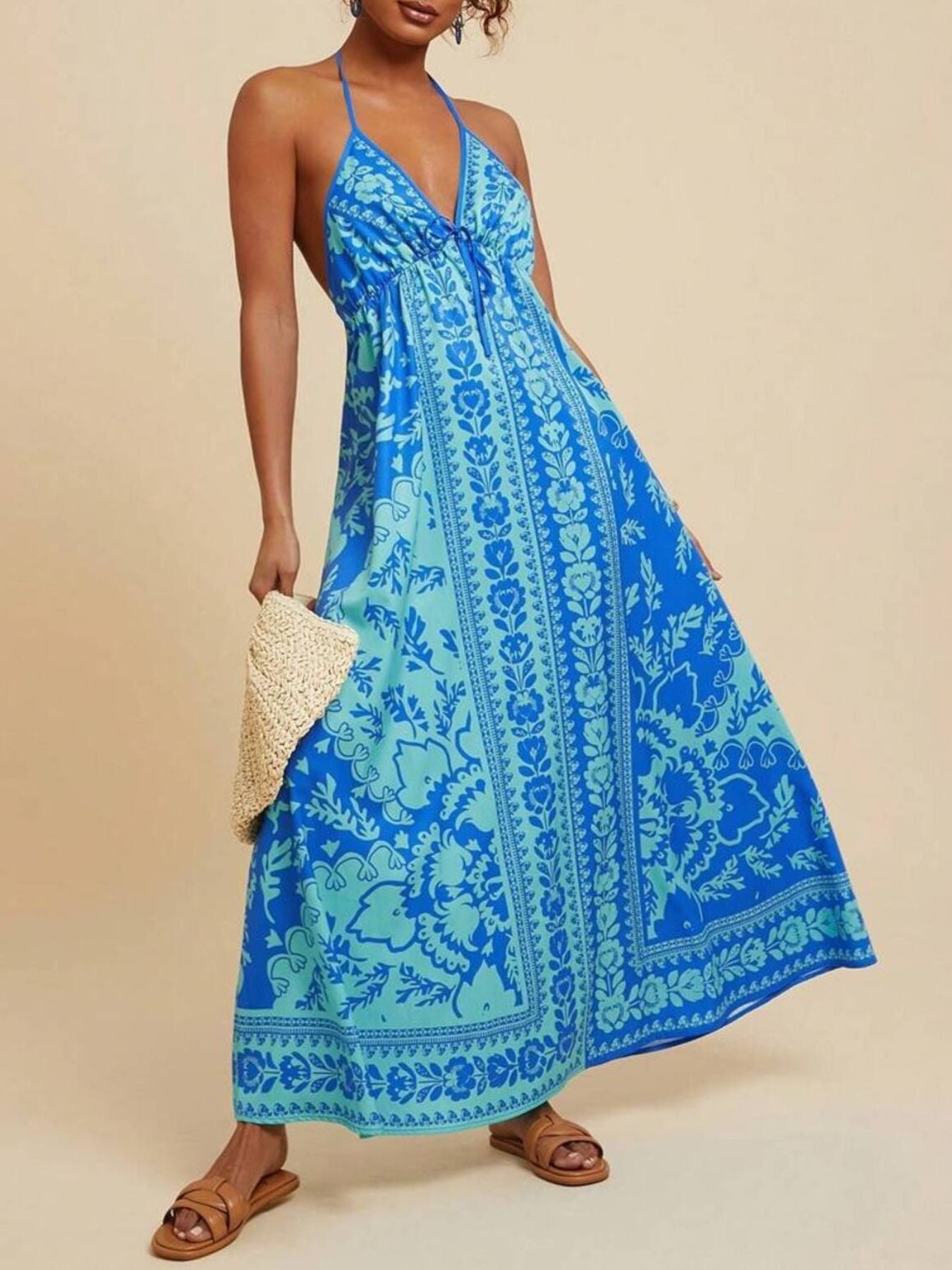 Woman wearing a blue patterned dress on a beige background