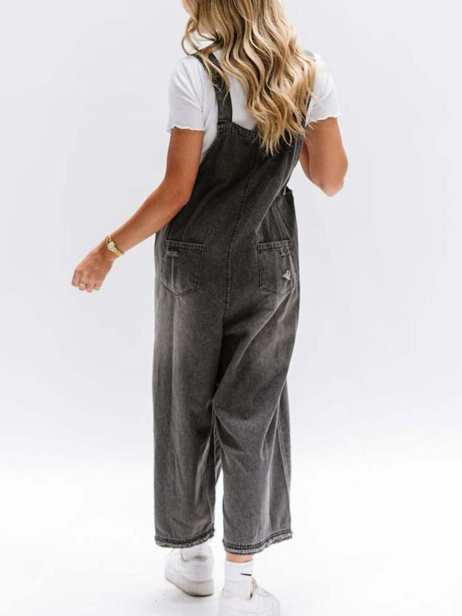Person wearing gray overalls on a white background