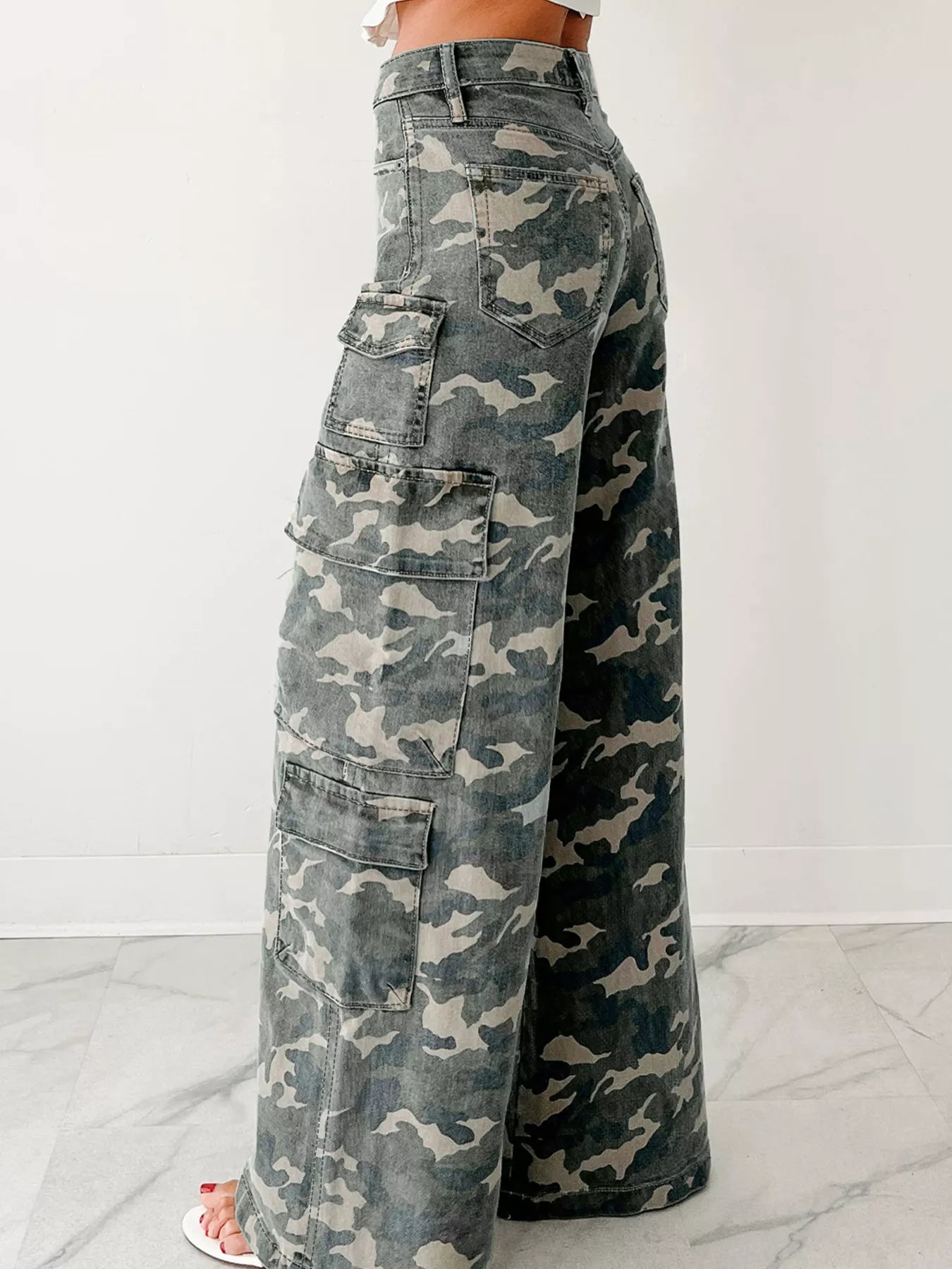 Camouflage cargo pants on a white background