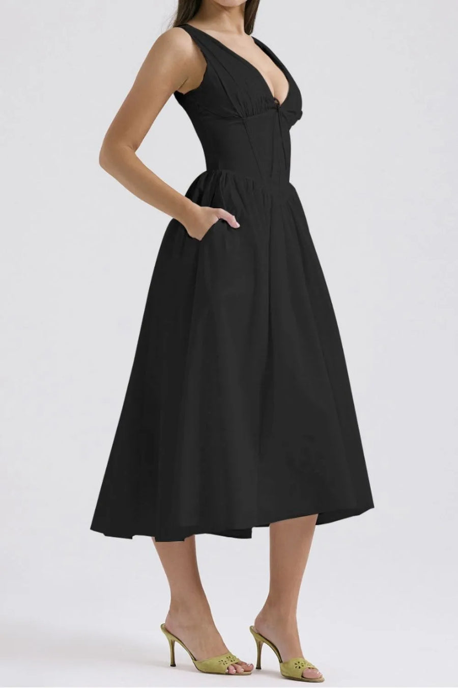 Black dress worn by a model on a white background