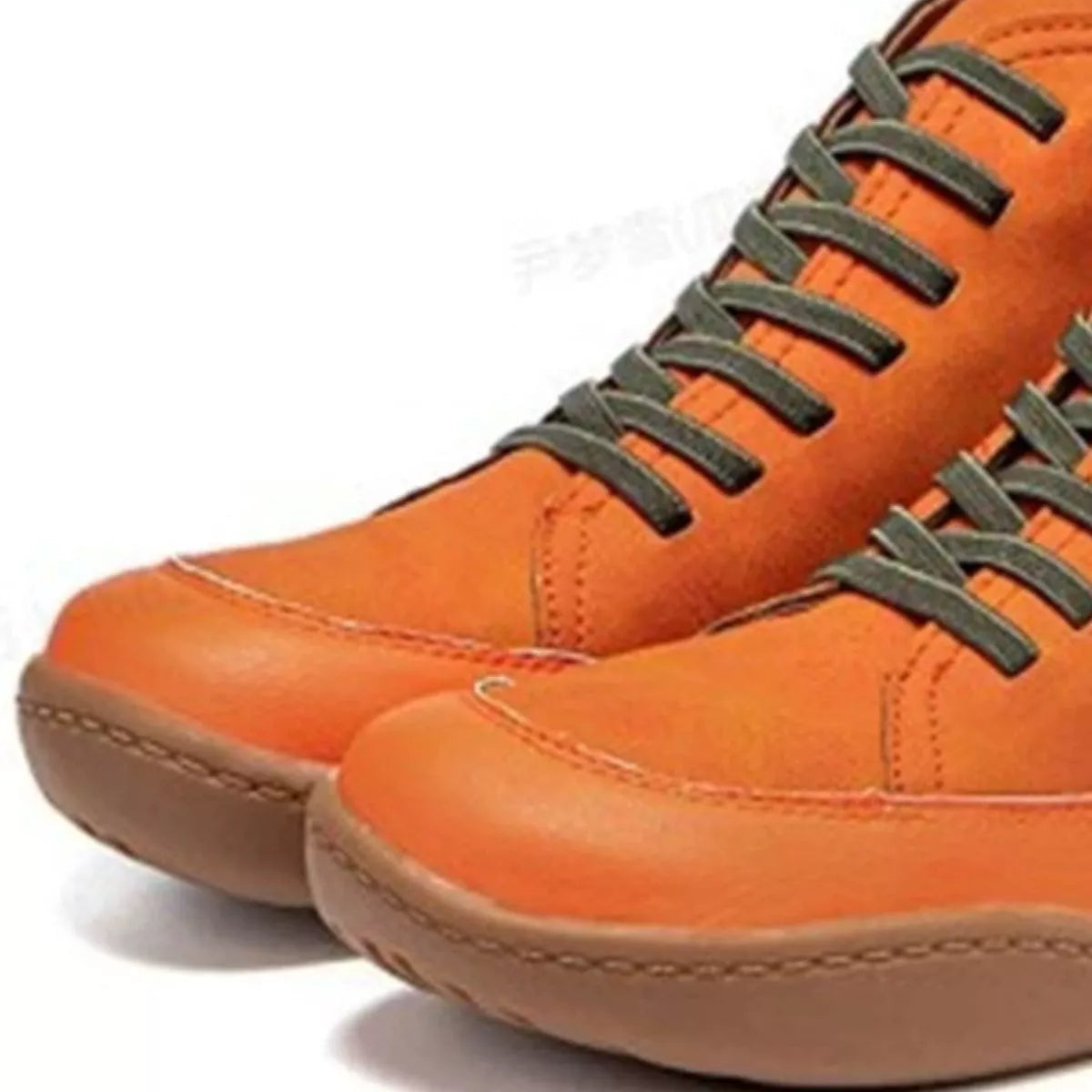 Orange leather shoes with green laces on a white background