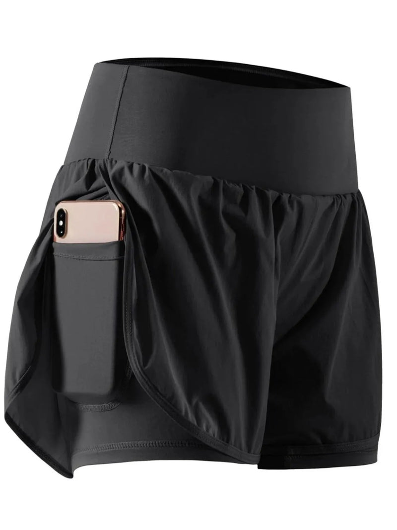 Black athletic shorts with a pocket holding a phone on a white background
