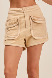 Beige shorts with pockets on a beige background