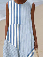 Person wearing a blue and white striped dress on a beach.