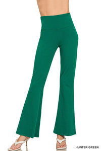 Hunter green bell-bottom pants on a white background