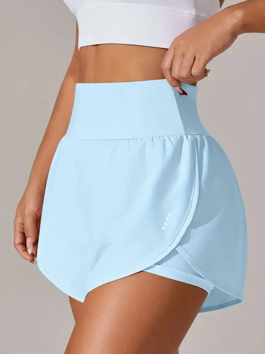 Light blue skirt worn by a person on a neutral background