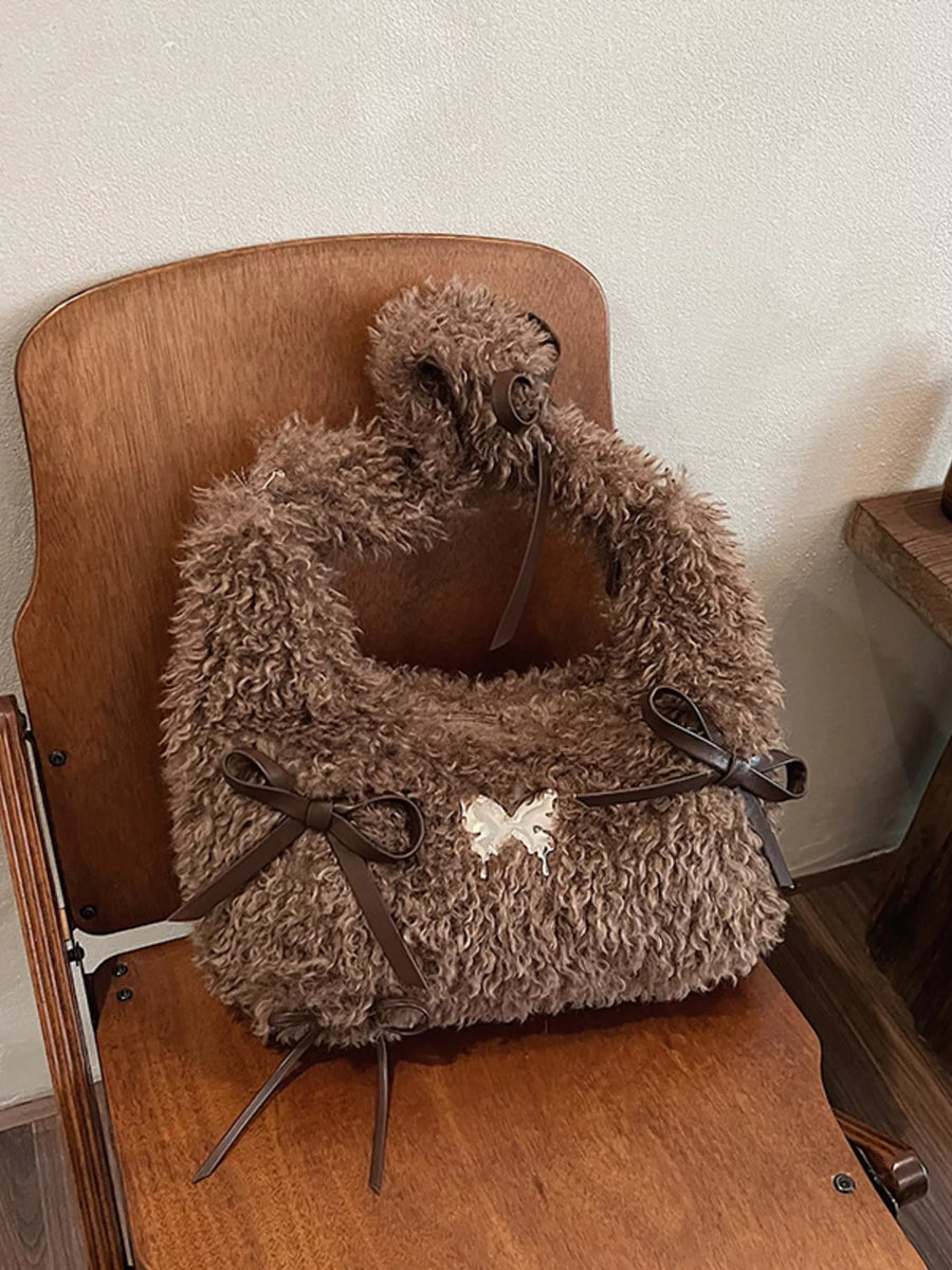 Brown fluffy pet carrier on a wooden chair against a white wall